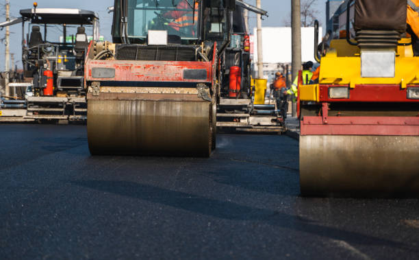 istock Asphalt road roller with heavy vibration roller compactor press new hot asphalt on the roadway on a road construction site. Heavy Vibration roller at asphalt pavement working. Repairing. 1307564863