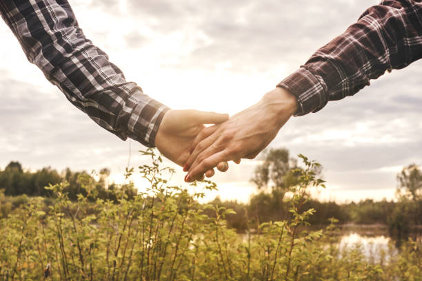 istock Couple hold hands each other. Hands close-up. 1307565520