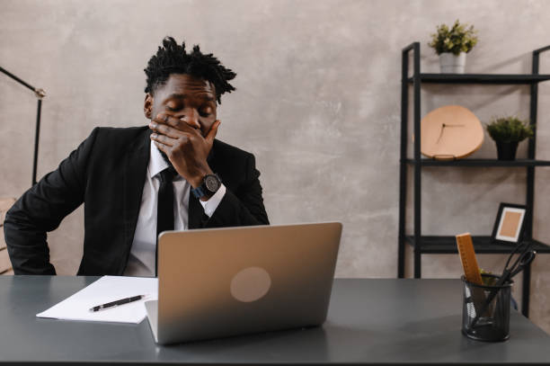 istock Black Businessman using laptop for analyzing data stock market, forex trading graph, stock exchange trading online. reaction to falling stocks 1307565525