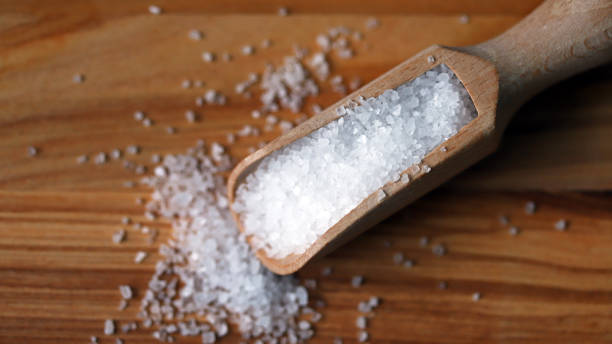 istock Sea salt in a wooden spatula. 1307566302