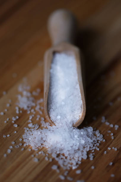 Sea salt in a wooden spatula. stock photo