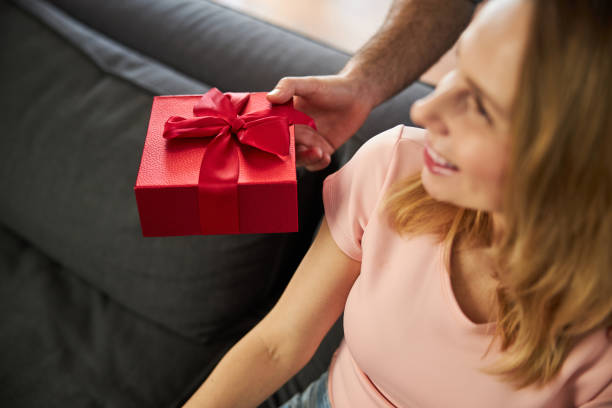 istock Loving man giving present to his charming wife 1307568106