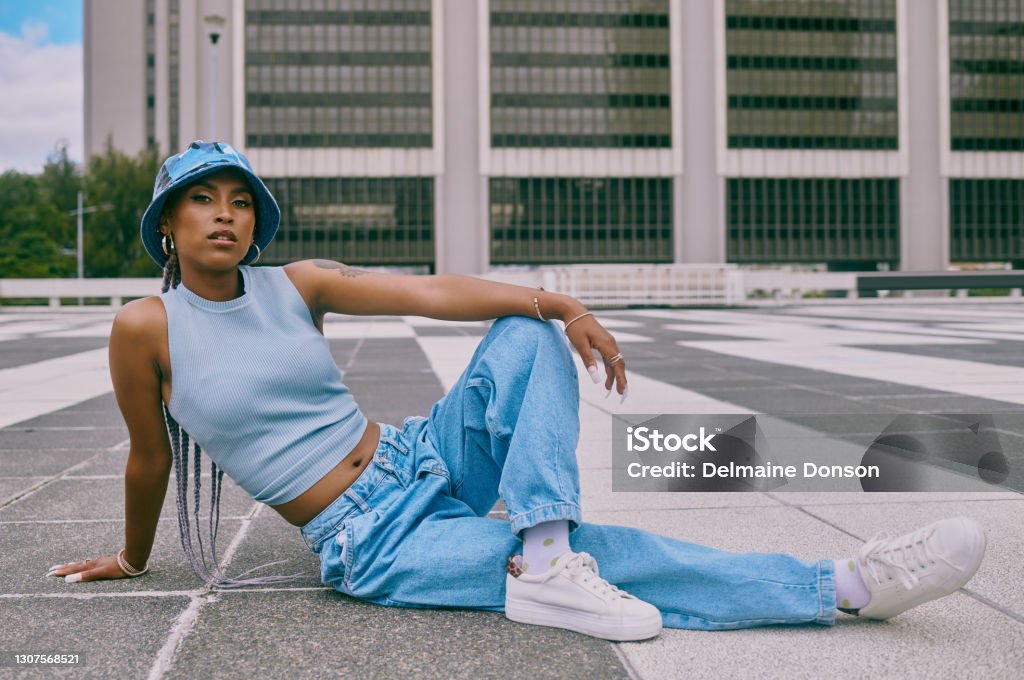It's the denim that does it for me Shot of a trendy young woman posing against a city background Fashion Stock Photo