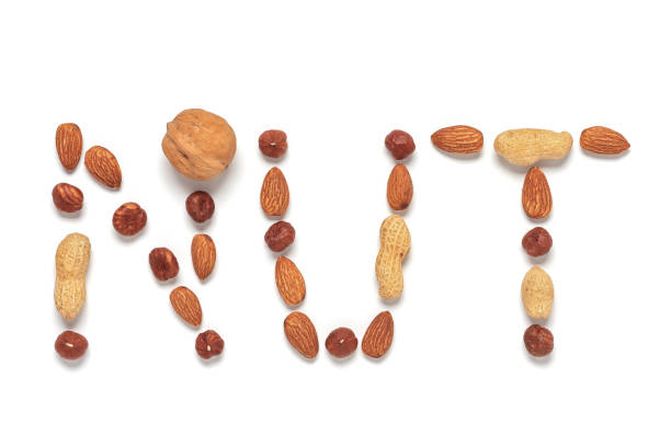 istock Collection of various nuts. The word nut made from different nuts isolated on white background. Creative layout. Top view, flat lay. 1307569586