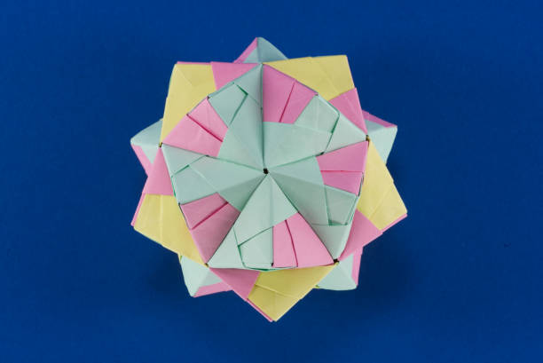 istock Self-made colorful origami star cube on blue background. 1307571132