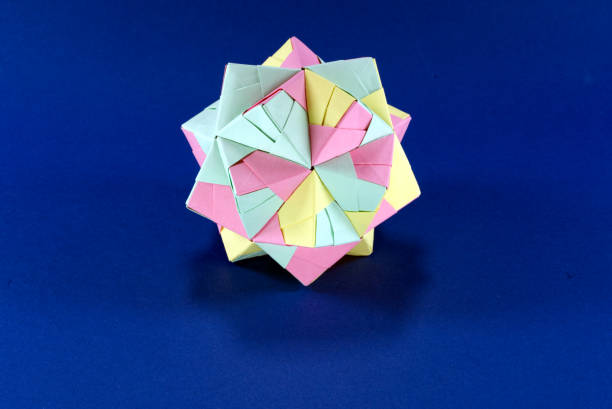 istock Self-made colorful origami star cube on blue background. 1307571133