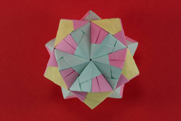 istock Self-made colorful origami star cube on red background. 1307571156