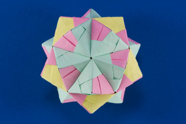 istock Self-made colorful origami star cube on blue background. 1307571160