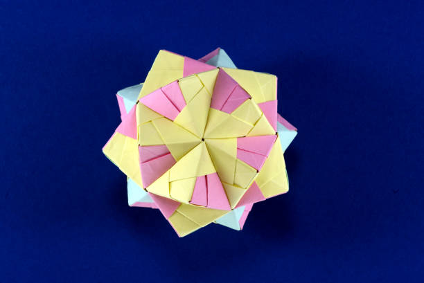 istock Self-made colorful origami star cube on blue background. 1307571166