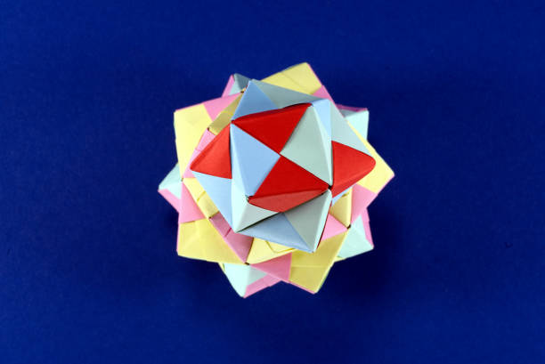 istock Self-made colorful origami star cube on blue background. 1307571170