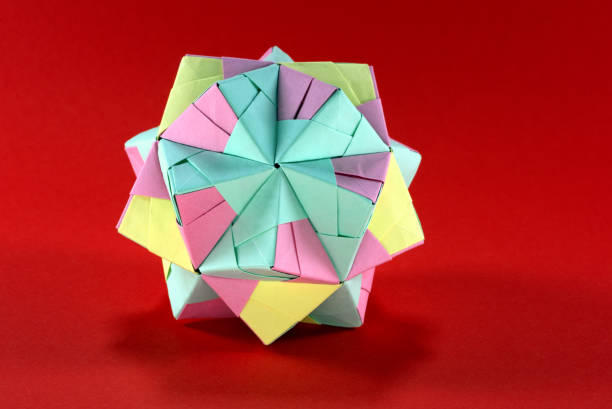 istock Self-made colorful origami star cube on red background. 1307571204