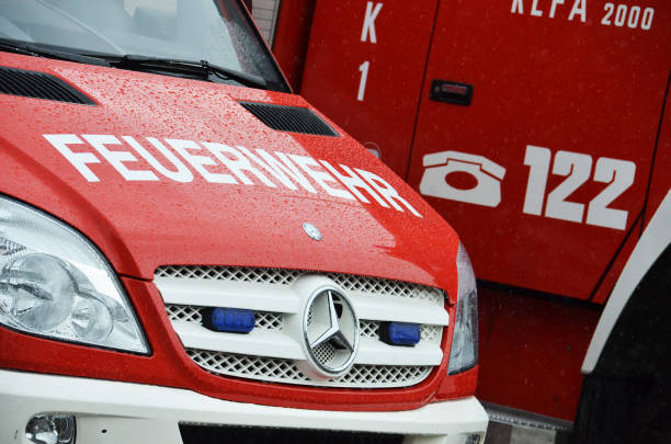 Fire brigade The front of aire brigade vehicle with the inscription "Feuerwehr" (fire brigade) with another fire brigade vehicle in the background in Austria europa mythological character stock pictures, royalty-free photos & images