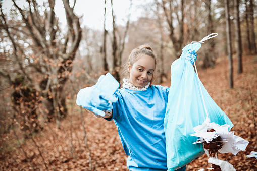 Modern Female Teenager Taking Selfie With Garbage Bag While Cleaning Up Park