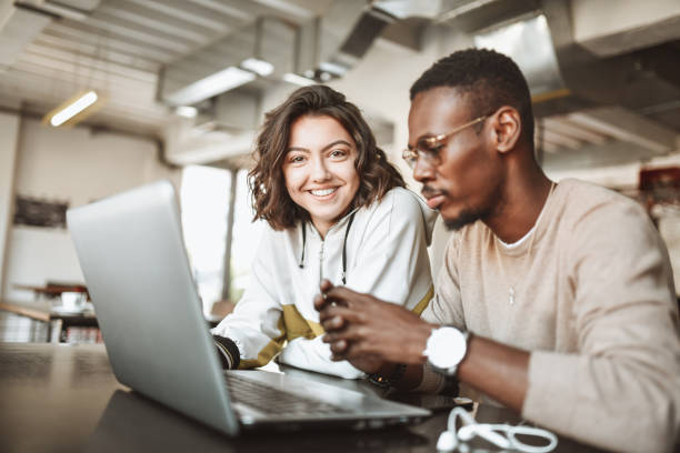 istock Multiethnic Couple Analyzing School Work Together On Laptop 1307573880