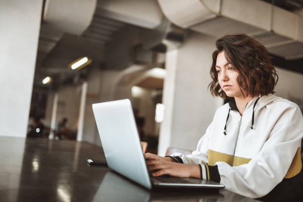 istock Serious Female Doing Freelance Work On Laptop At Home 1307574449