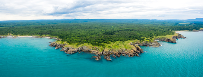 Aerial panoramic view of the wild beaches, surrounded by rocks and green dense forests on the southern Black Sea coast, Bulgaria