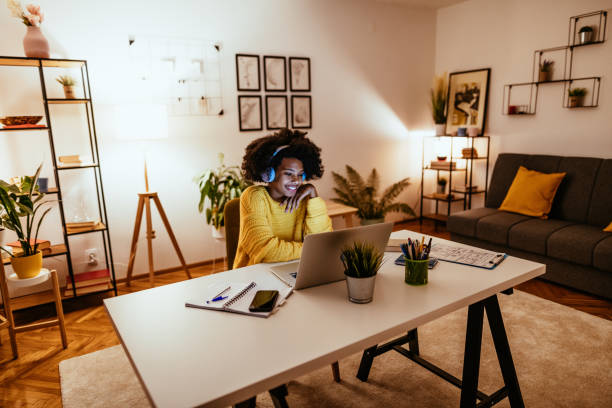 young african american woman has video call with colleagues - working at home imagens e fotografias de stock