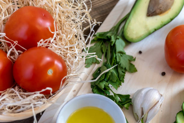 istock Tomatoes, cucumbers and avocado on the table, olive oil and balsamic vinegar, garlic, vegetables, vegetarianism, healthy eating 1307579231