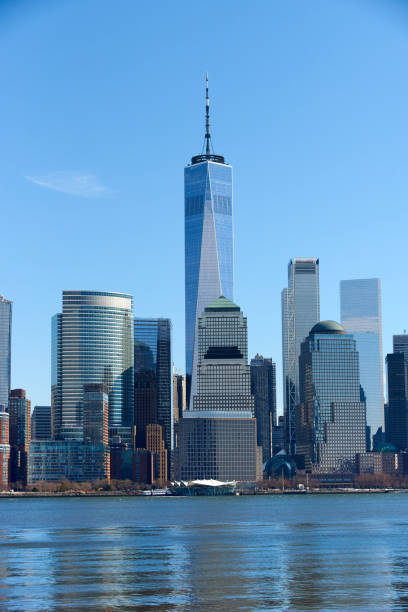 A view of the Lower Manhattan Skyline as seen from the Newport, Jersey City Waterfront. A view of the Lower Manhattan Skyline as seen from the Newport, Jersey City Waterfront on cloudless day. Liberty Tower anchors the view. The Hudson River is in the foreground. liberty tower stock pictures, royalty-free photos & images