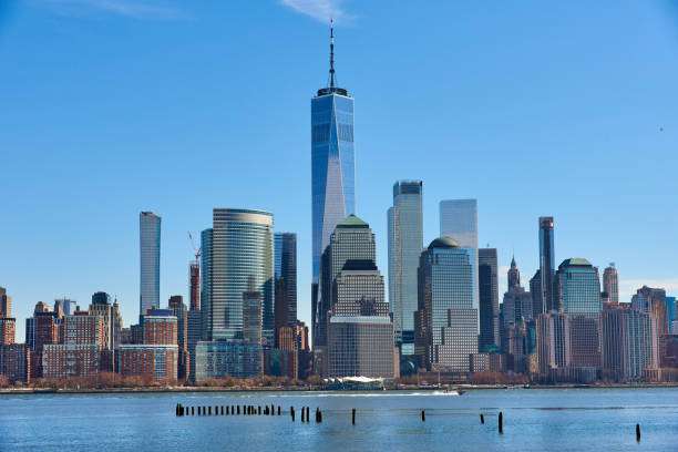 A view of the Lower Manhattan Skyline as seen from the Newport, Jersey City Waterfront. A view of the Lower Manhattan Skyline as seen from the Newport, Jersey City Waterfront on cloudless day. Liberty Tower anchors the view. The Hudson River is in the foreground. liberty tower stock pictures, royalty-free photos & images