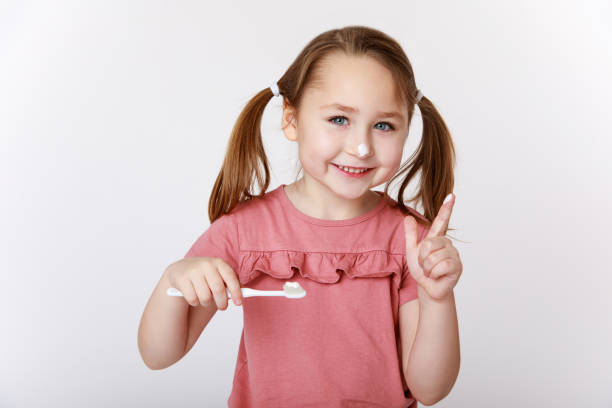 istock Smiling girl with toothpaste on her nose 1307582795