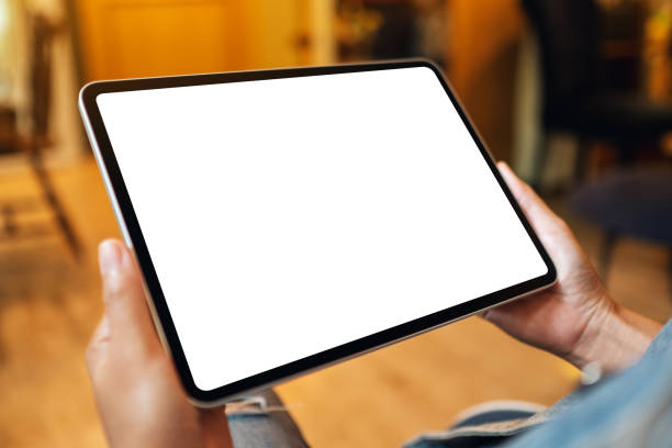 istock a woman holding digital tablet with blank white desktop screen 1307583078