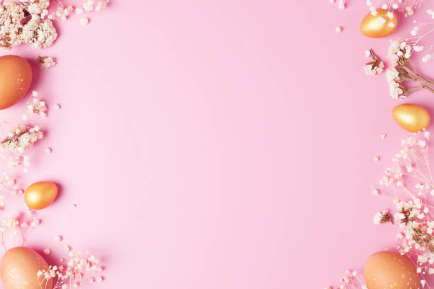 istock Easter eggs with flowers on pink background. Flat lay, copy space. 1307585796