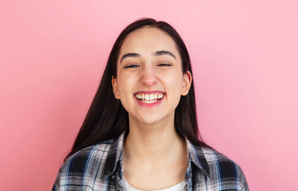 istock Caucasian woman's portrait isolated on coral pink studio background with copyspace 1307586003