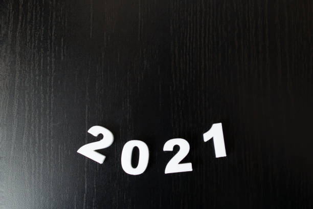 istock White numbers 2021 on black background, new year 1307586809
