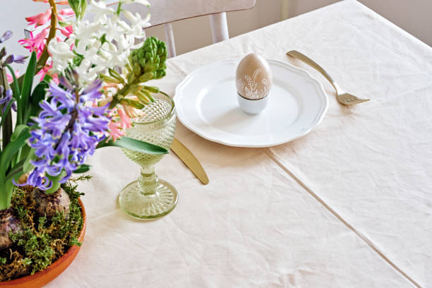 istock Zero Waste Easter table setting with natural Hyacinths flowers in wooden bowl. Selective focus, home festive atmosphere 1307590180