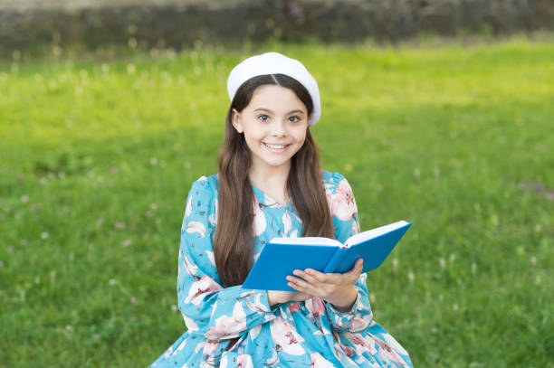 istock Opening door to knowledge. Happy kid hold book summer outdoors. Knowledge day. Back to school. September 1. School and education. Knowledge and skills. Book crossing. Explore the worlds knowledge 1307591546