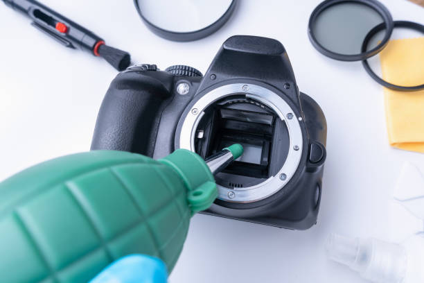 istock A hand with a green air blower is about to clean the camera matrix from dust 1307591620