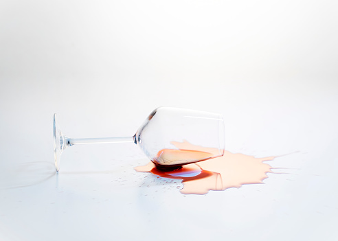 Glass of red wine have fallen on the white ground