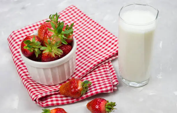 Tasty fresh milk on a white wooden background. strawberries and glass of milk. Strawberry. copy space
