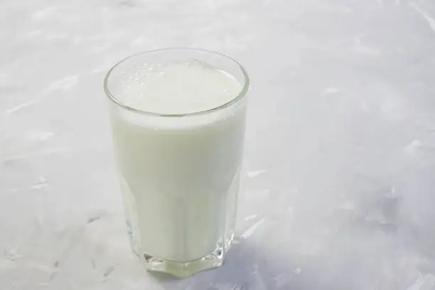 Tasty fresh milk on a white wooden background. a glass of milk. copy space