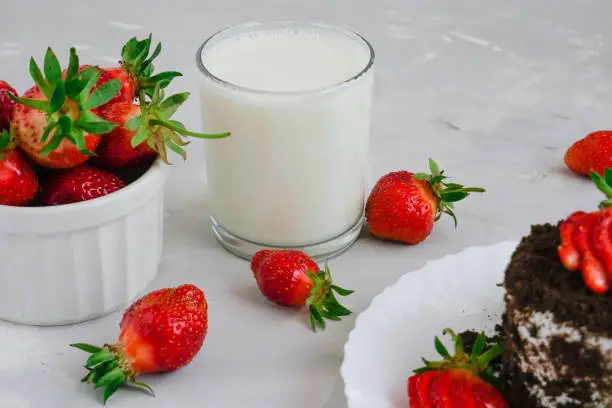 Tasty fresh milk on a white wooden background. homemade cookies and a glass of milk. Strawberry. copy space