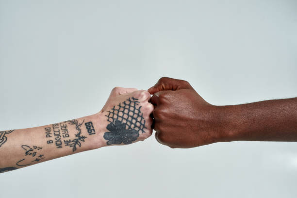 istock Multiracial couple bumping their fists together 1307597020