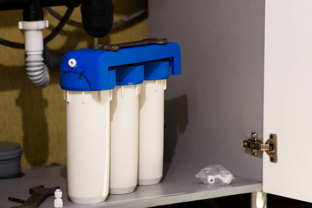 istock Water filter cartridges in the kitchen. Drinking water filtration system in the kitchen. Clean water at home 1307597674