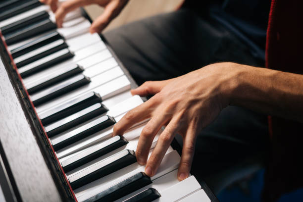 istock Top view of unrecognizable musician man playing on synthesize at home studio. 1307598729