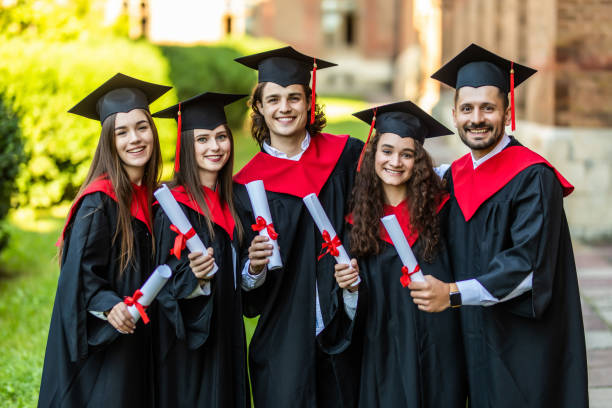 istock Five graduates posing in front of the university 1307600266