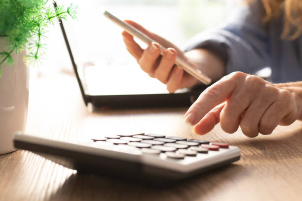 business woman hand with calculator and mobile phone business woman hand with calculator and mobile phone civil servant stock pictures, royalty-free photos & images