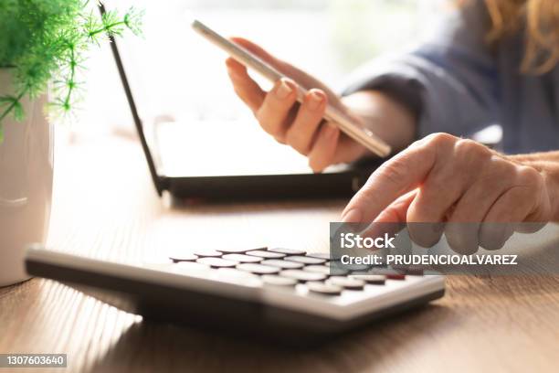 Business Woman Hand With Calculator And Mobile Phone Stock Photo - Download Image Now
