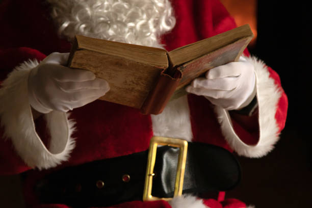 istock santa claus hands with old book 1307603746