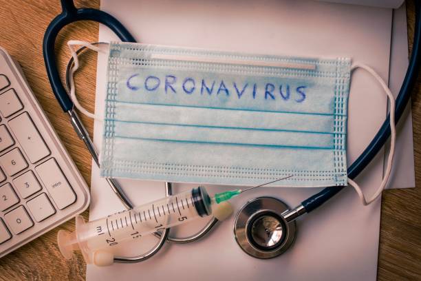 istock coronavirus pandemic mask and vaccine 1307603772