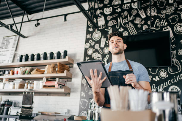 istock Smiling owner at his coffee shop 1307604055