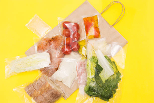 istock Salad dinner set: chicken, lettuce, tomatoes, peking cabbage, cheese, bacon, bread, olive oil sauces and spices. A set for delivering food for dinner on a yellow background. I cook at home 1307604154