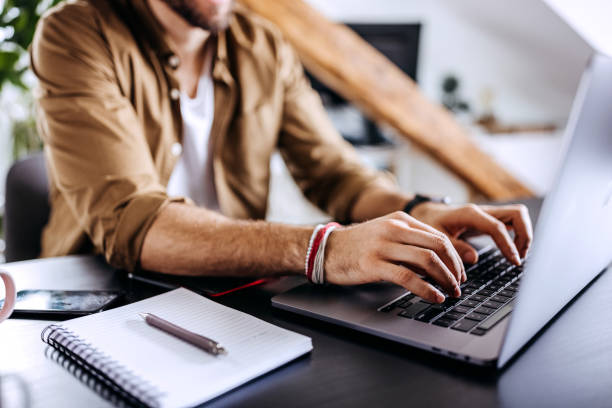 istock Hands of an unrecognisable man typing on his laptop. 1307604965