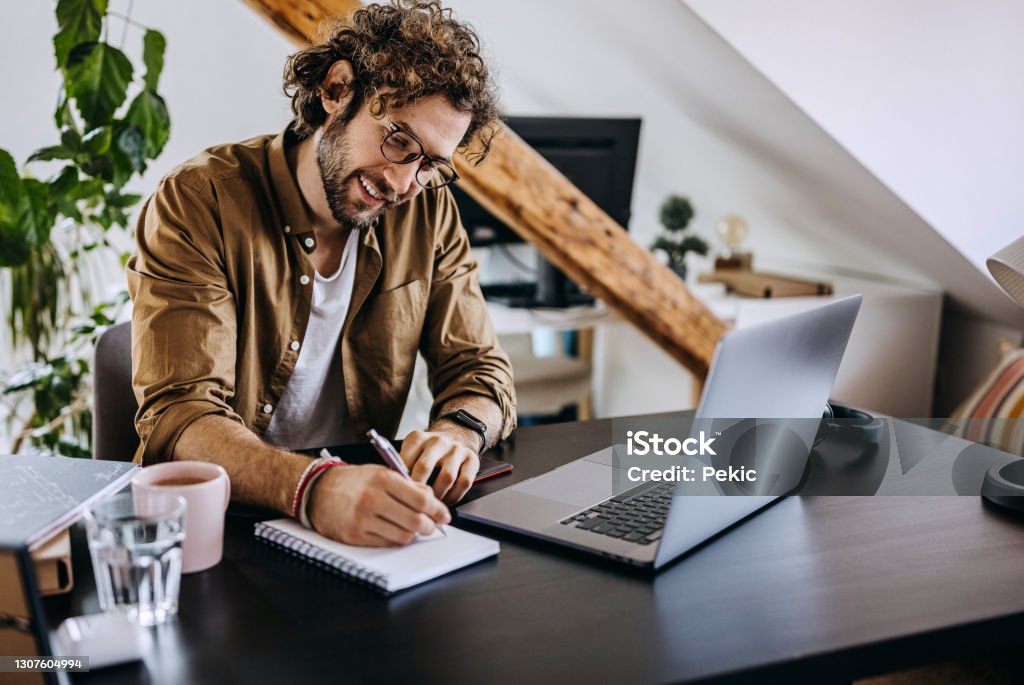 Man Notes Young Man Taking Notes While Having Video Call At His Home Office Stock ...