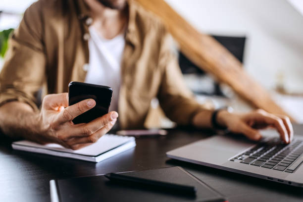 istock Unrecognisable businessman booking tickets online using smartphone 1307605025
