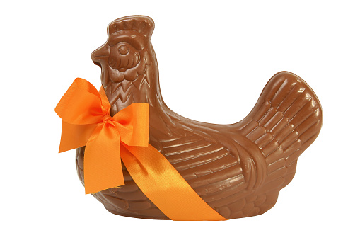Chocolate Easter hen with orange ribbon, cut out and isolated on a white background